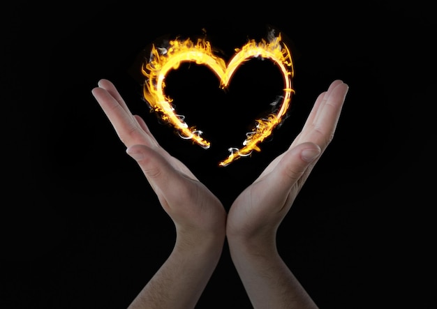 hands with heart fire icon over. Black background