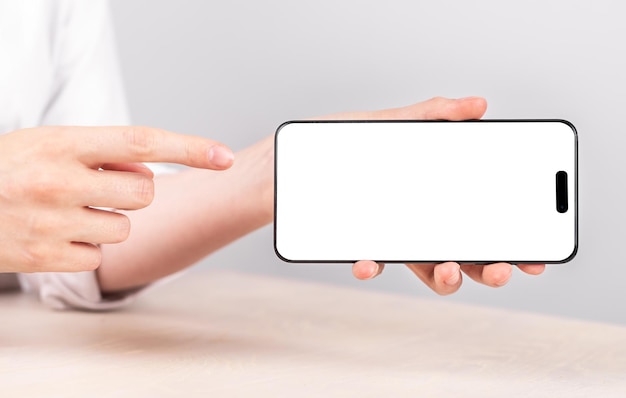 Hands with iphone 14 phone horizontal screen mockup