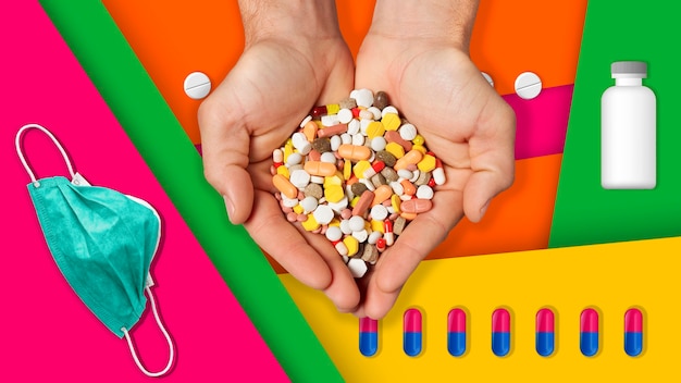 Hands with medicines on colorful background