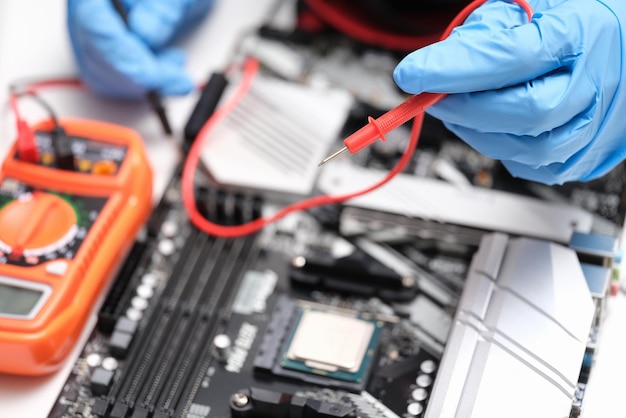 Hands with a multimeter to check electronic equipment