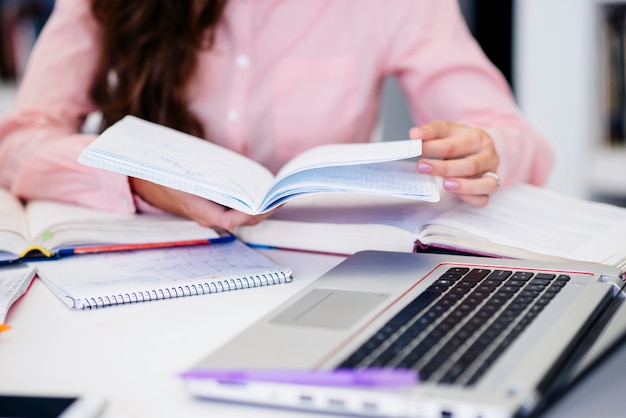 Hands with notebook on workplace