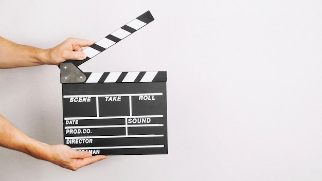 Photo hands with opened clapperboard