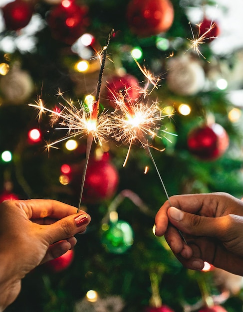 Photo hands with shiny sparks and details and background christmas decoration