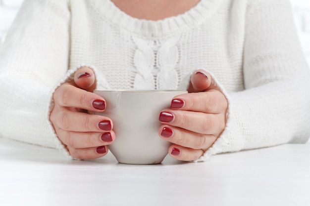 Hands with tea cup