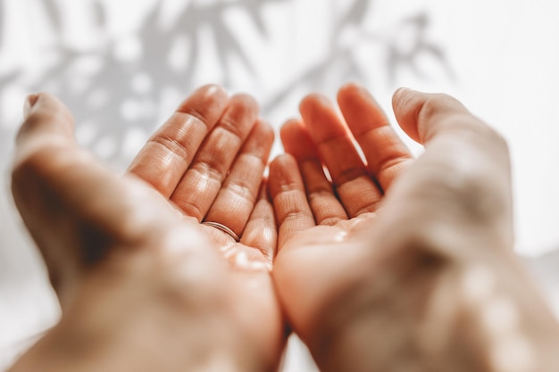 Photo hands of woman catching sunlight