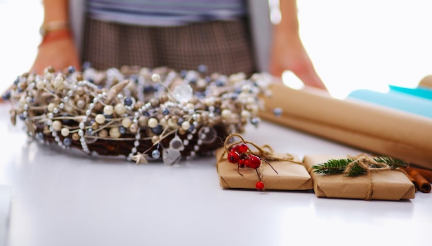 Hands of woman decorating christmas gift box Hands of woman