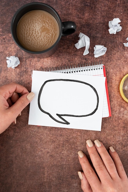 Photo hands of woman holding thought bubble drawing on paper with copy space coffee cup and crumpled papers businesswoman representing new ideas and opinions for business