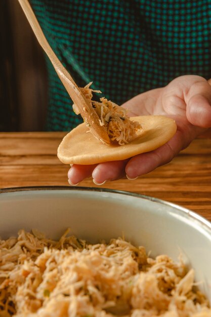 Hands of woman preparing brazilian croquette 