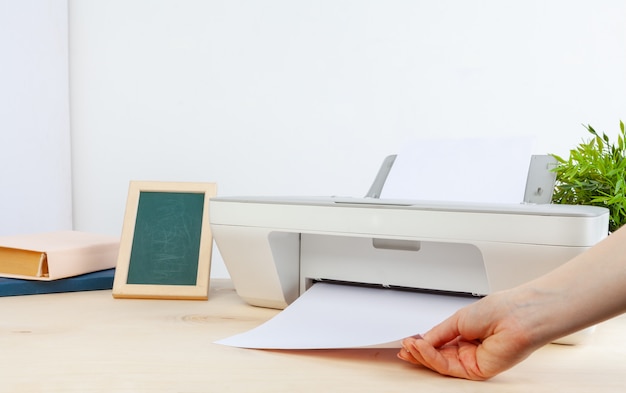 Hands of a woman using a copying machine close up