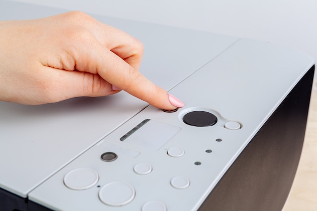 Hands of a woman using a copying machine close up