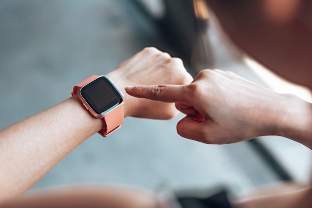 Hands woman using a smartwatch