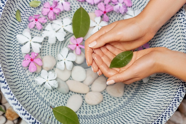 Hands of woman with natural manicure.Spa treatment and massage for female hands.Close up.Spa skin care concept. Cosmetology.