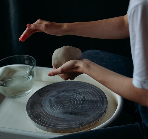 Hands working on a potters wheel