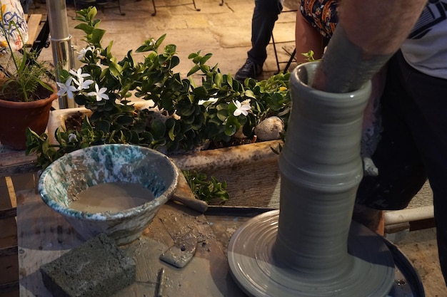 Hands working on pottery closup detail