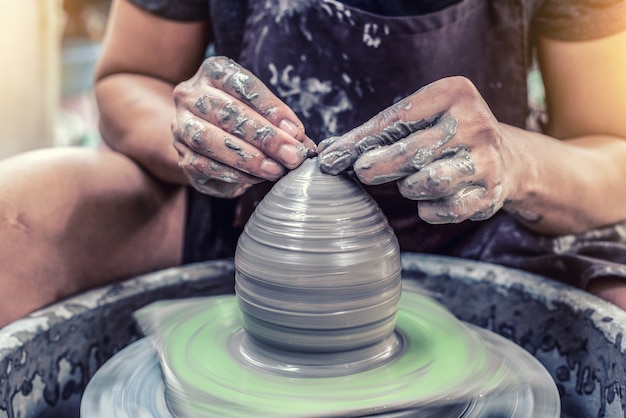 Hands working on pottery wheel