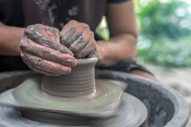 Hands working on pottery wheel