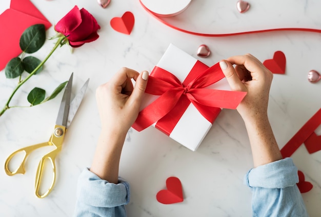 Hands wrapping a sweet present