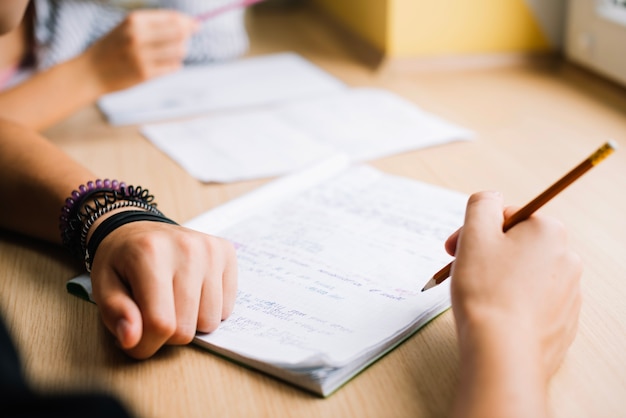 Hands of writing student