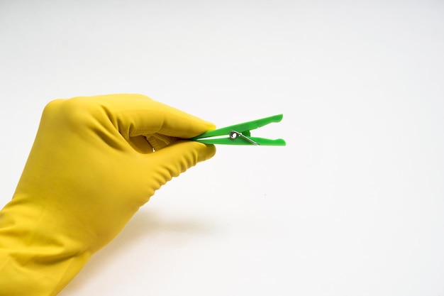 Hands in yellow rubber gloves on white background