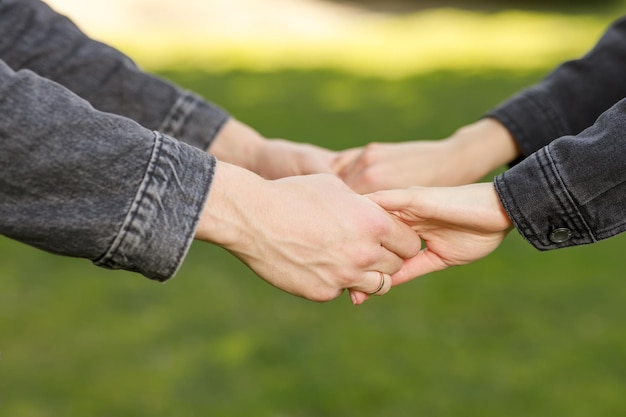 Hands of young couple holding each other