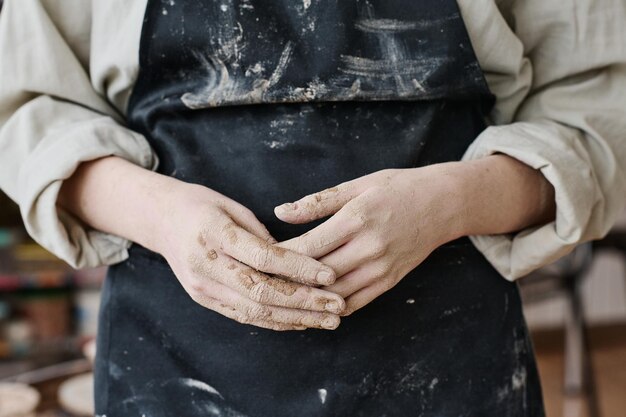 Hands of young female artisan or craftswoman skilled in creating pottery