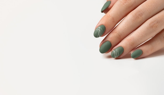 Premium Photo  Hands of a young woman with green olive matte nails on a  light gray background. manicure, pedicure beauty salon concept. copy space  for text or logo. gel polish and