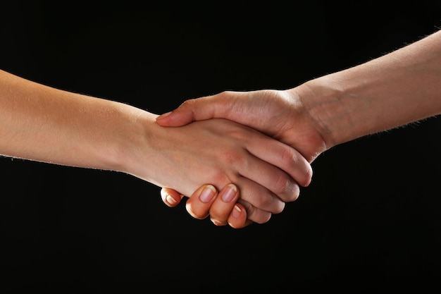 Handshake on black background