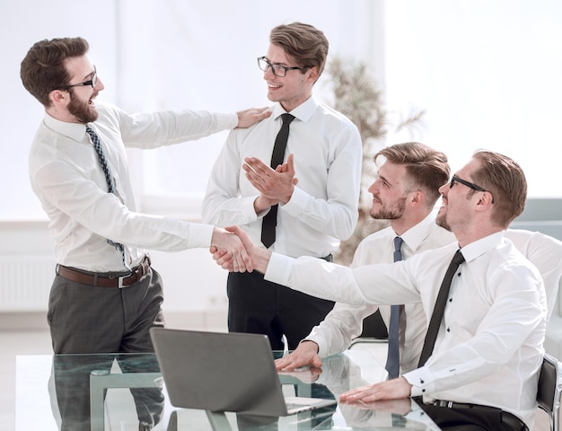 Handshake business colleagues in the workplace