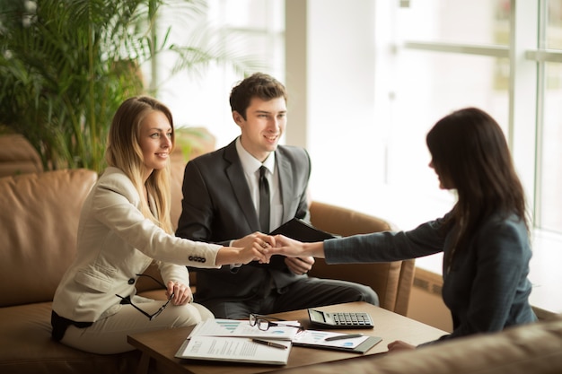 Handshake of business partners after discussing a new financial contract at the workplace in the office