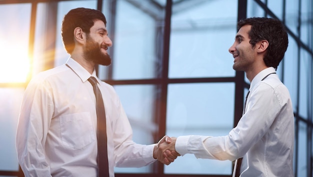 handshake business partners after discussion of the contract