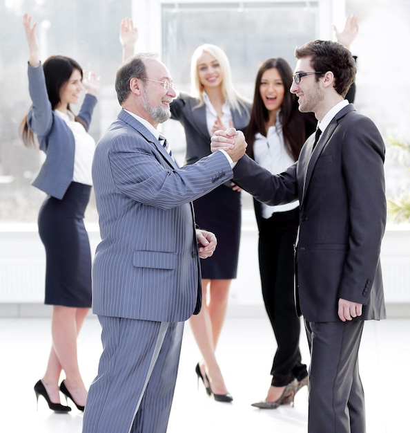 Handshake of business partners after signing the contract