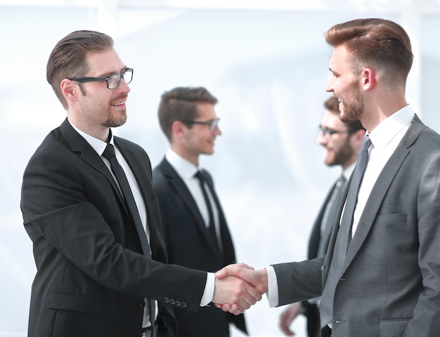 Handshake of business partners on a light background