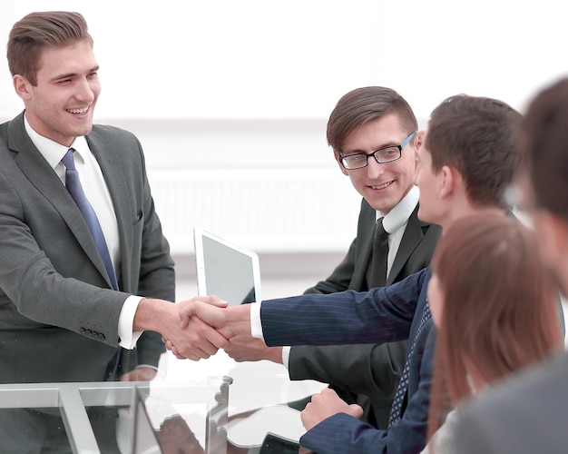 Handshake business partners at a meeting