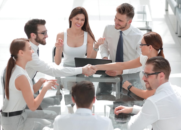 Handshake business partners at the negotiating table