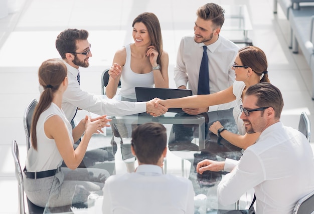 Handshake business partners at the negotiating tablethe concept of cooperation