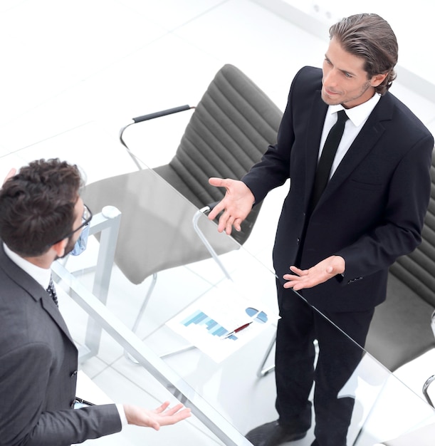 Handshake of business partners sitting at their Deskphoto with copy space