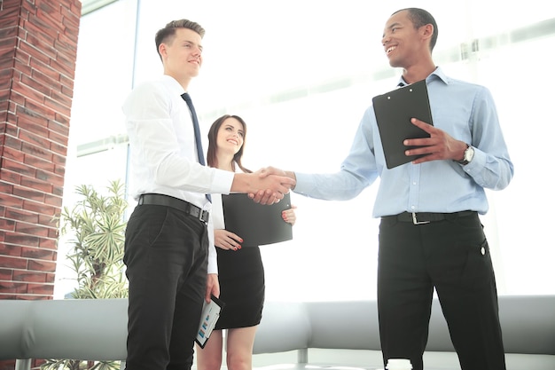 Handshake of business partners standing in the office