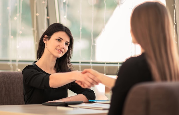 Handshake of business partners in the workplace in the office