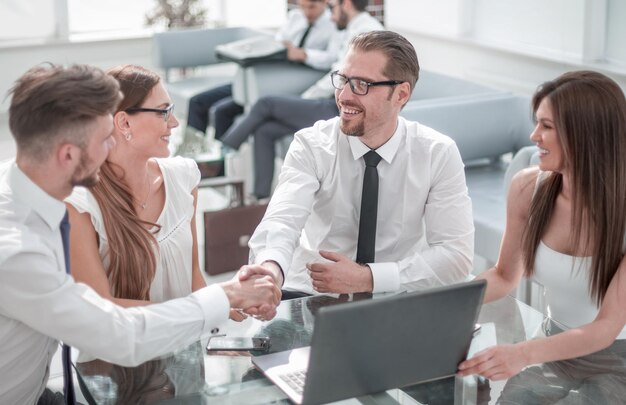 Handshake business people at the Desk