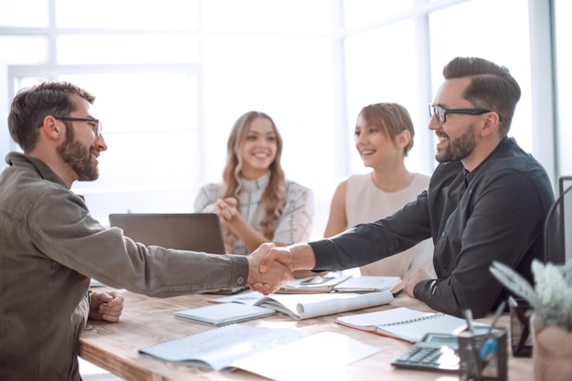 Handshake business people at a meeting in the office