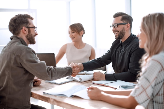 Handshake business people at a meeting in the office