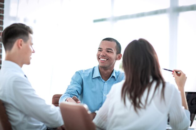 Handshake business people sitting at a Desk