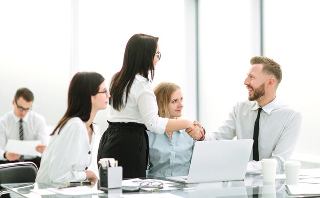 Handshake of business people in the workplace in the office