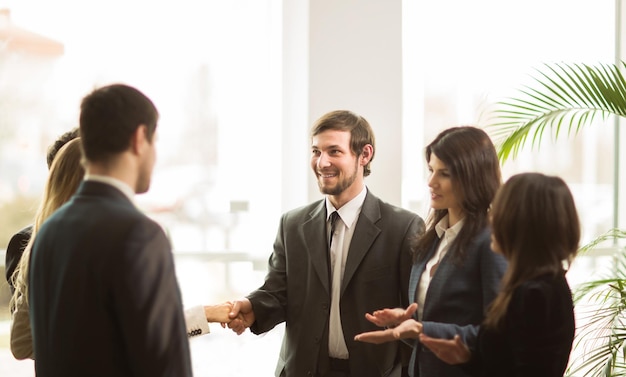 Handshake of businessmen. Conclusion a very important contract in the office standing