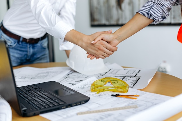 Handshake of businessmen in an office to close the deal