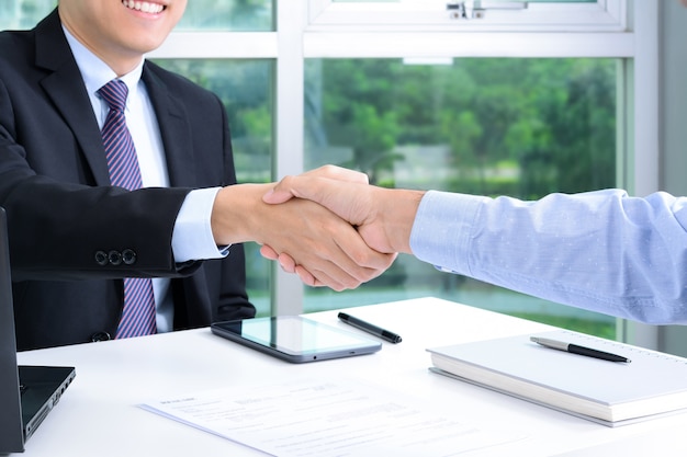 Handshake of businessmen in the office
