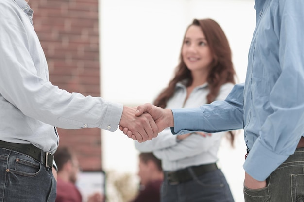 Handshake between businesspeople in a modern office