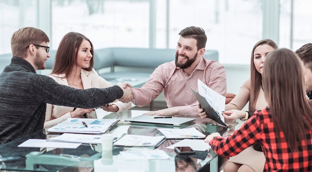 Handshake financial partners after the discussion of a new contract in the workplace in the office