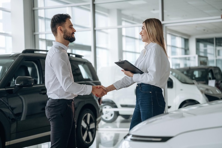 Photo handshake good to meet you man and woman are in the car dealership