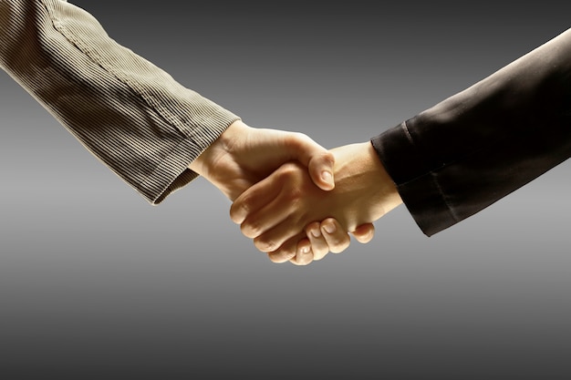 Handshake on a gray background.